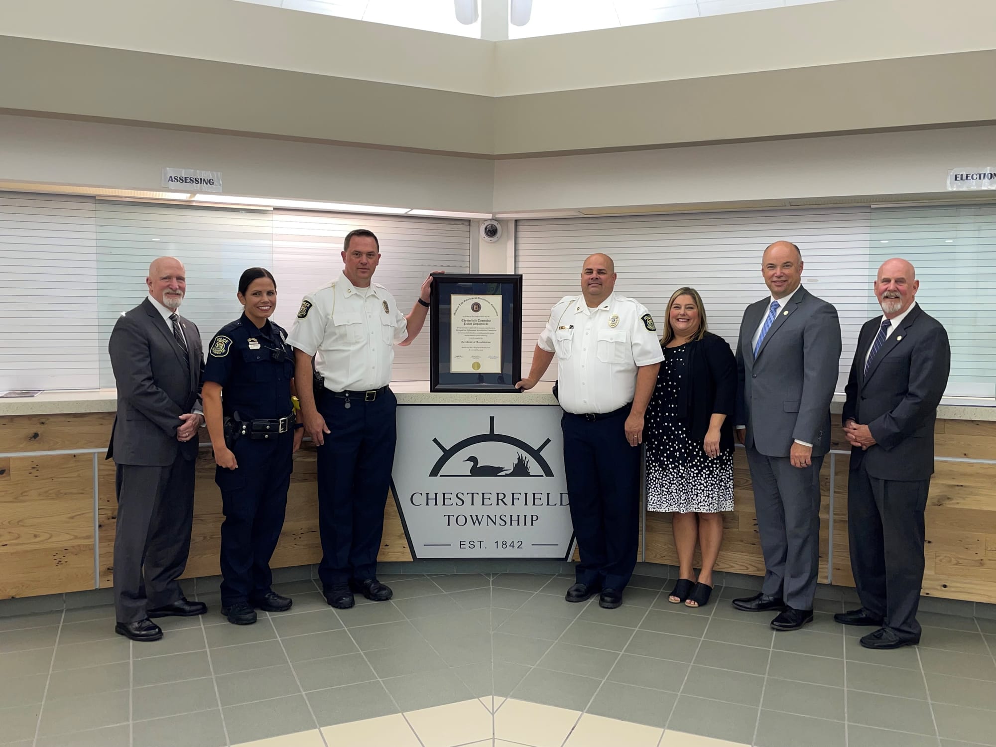 Chesterfield Township police command staff and township officials with the MLEAC accreditation certificate