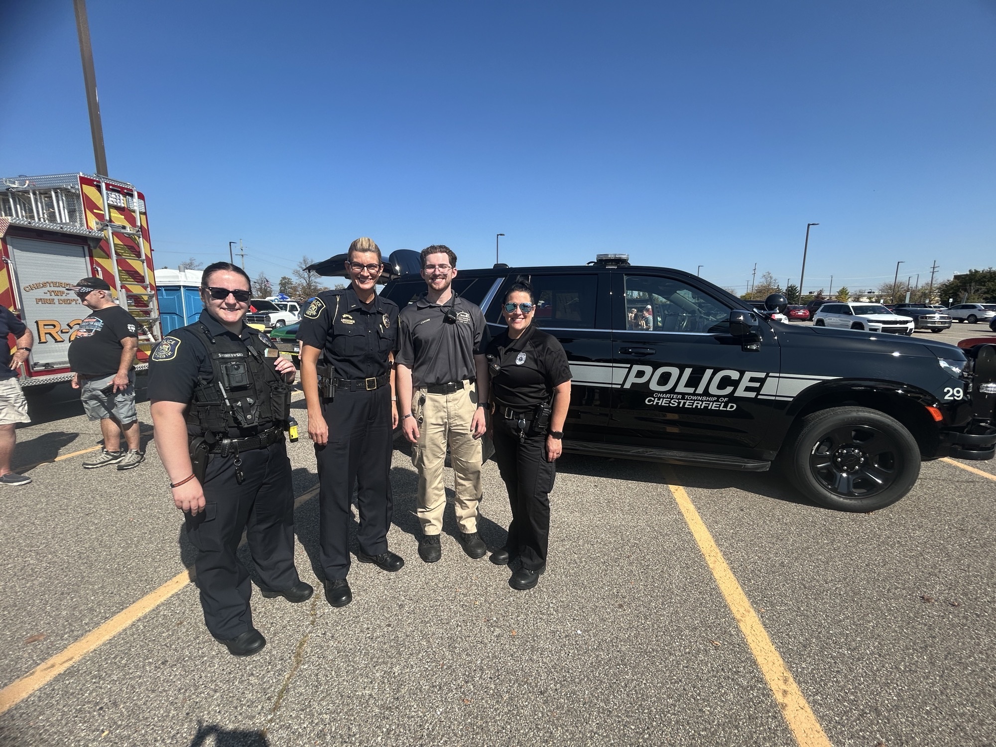 A cadet with officers at a 2025 community event