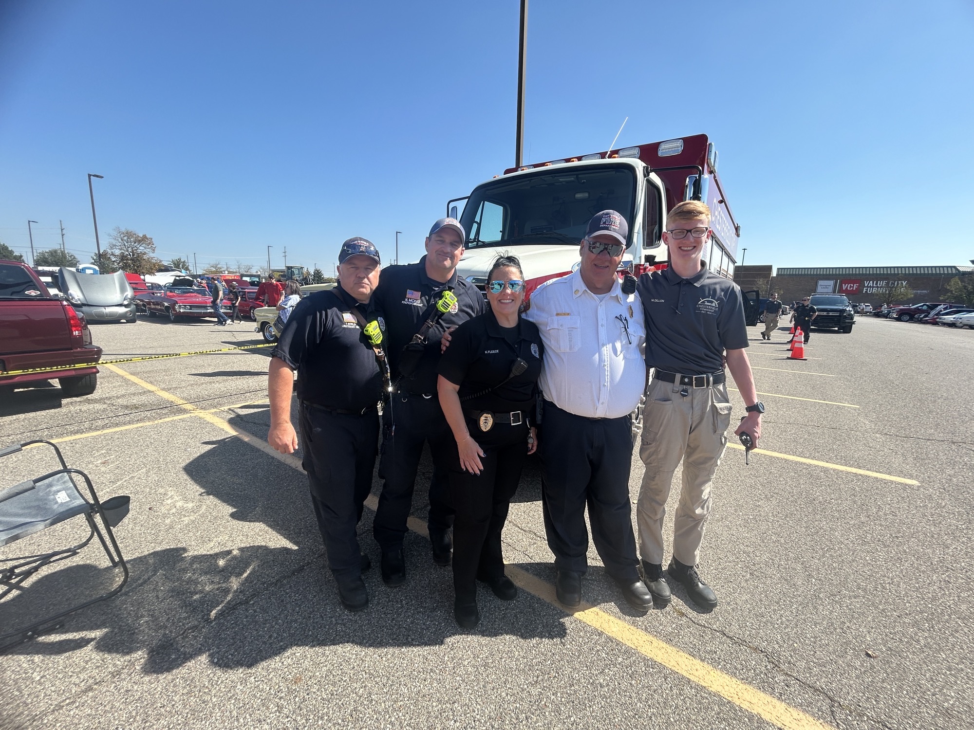 A cadet with officers and firefighters at a 2025 community event