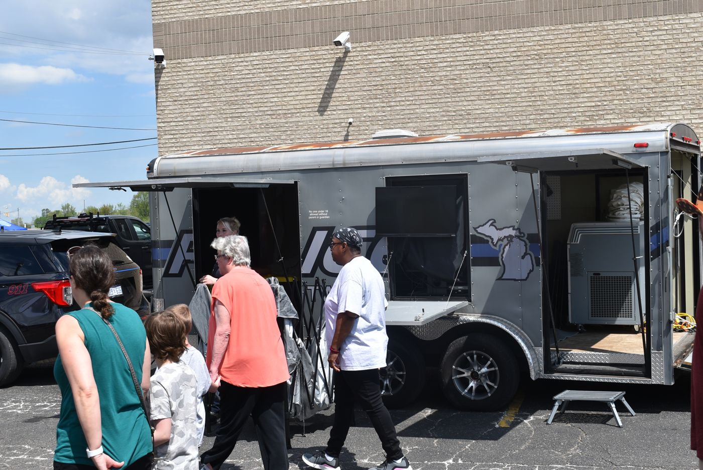 Visitors touring a police trailer at the open house