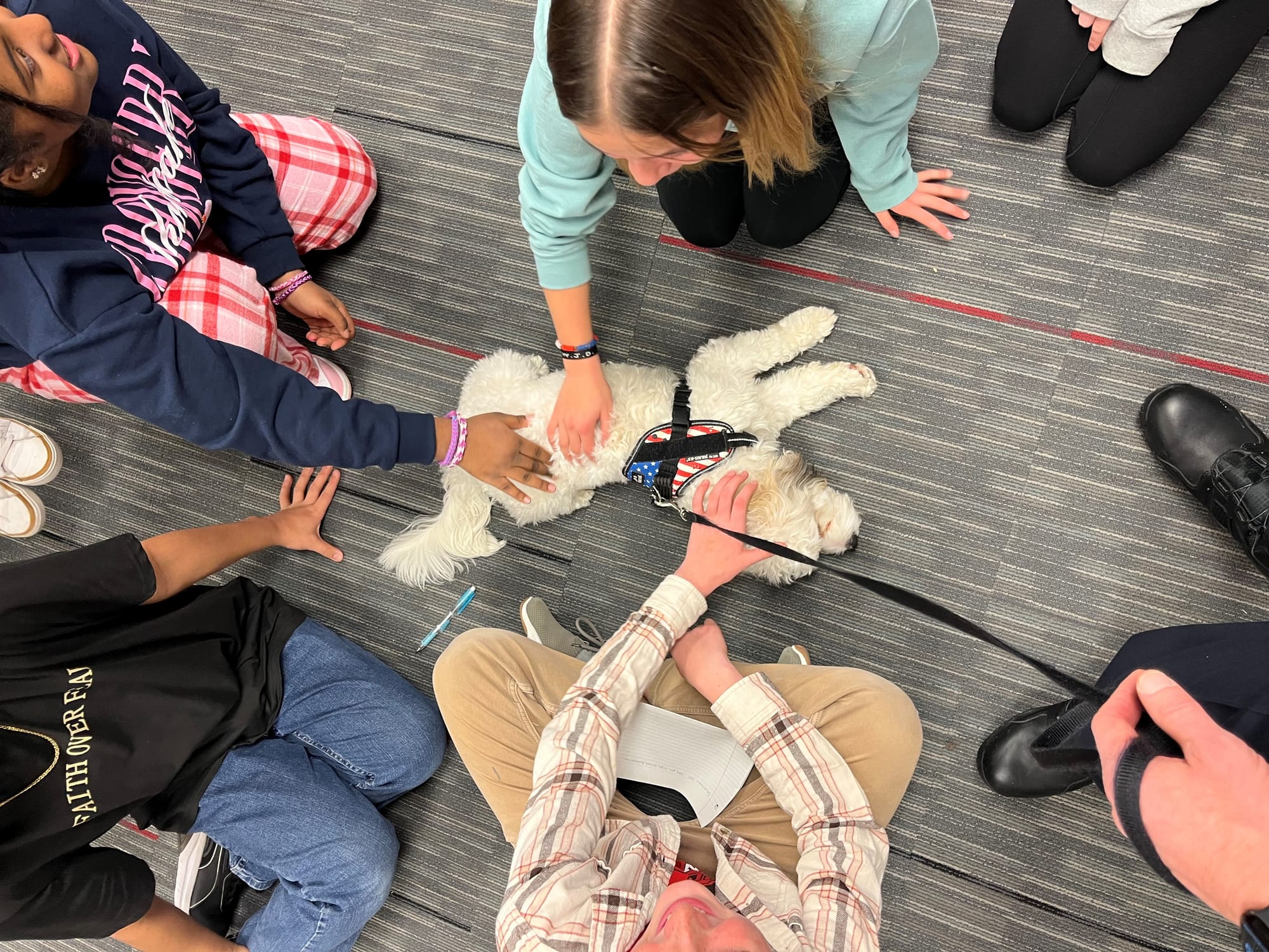 Children petting Chester, the comfort K-9