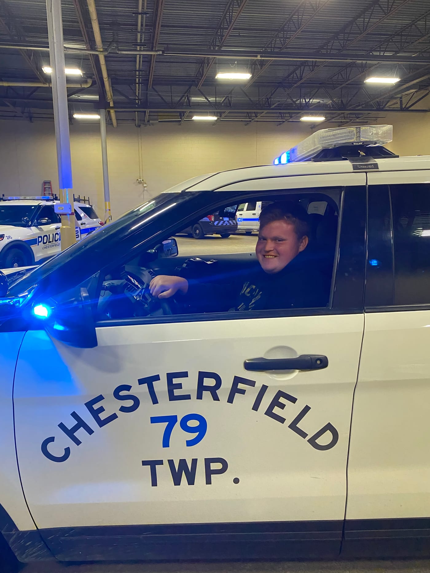 Citizens Academy participant in a Chesterfield Township patrol vehicle
