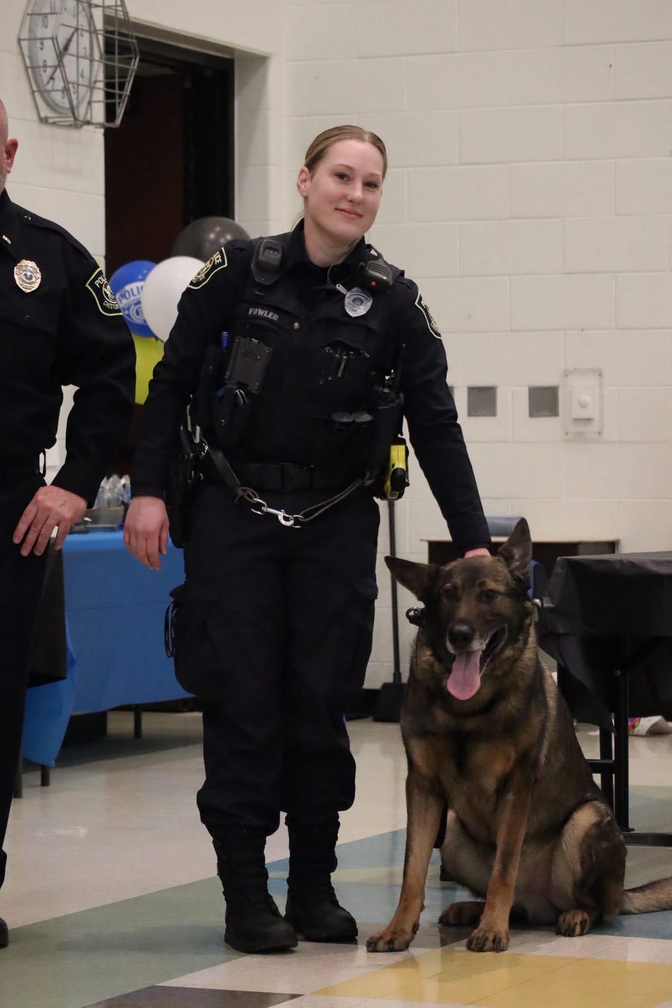 Officer Hallie Fowler with K-9 Hemi seated at her side