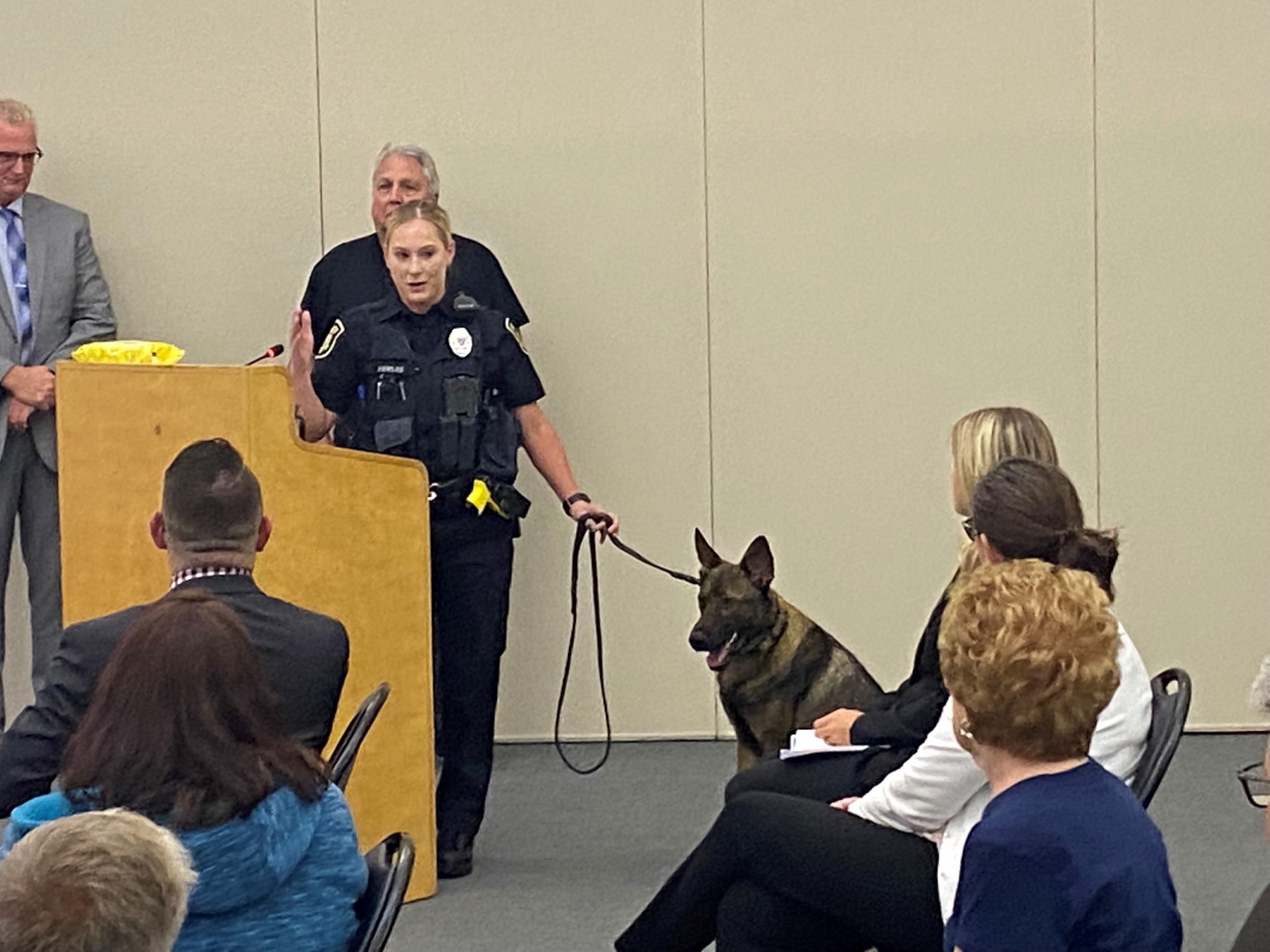 Officer Hallie Fowler introducing K-9 Hemi at a public meeting