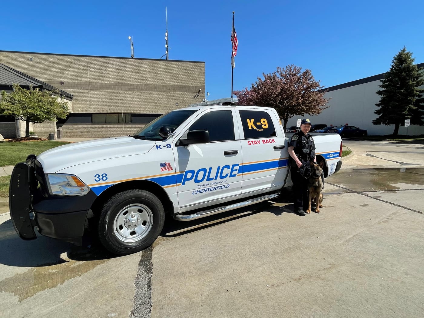 K-9 unit truck and handler outside the police station