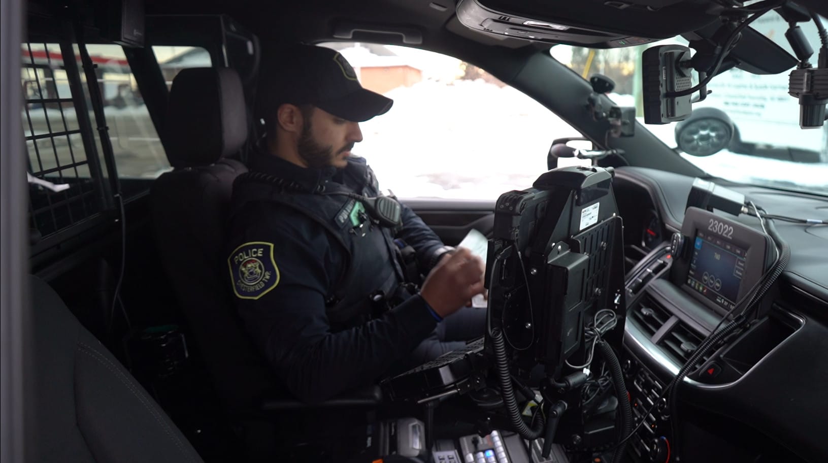Chesterfield Township officer at the in-car computer of a patrol vehicle