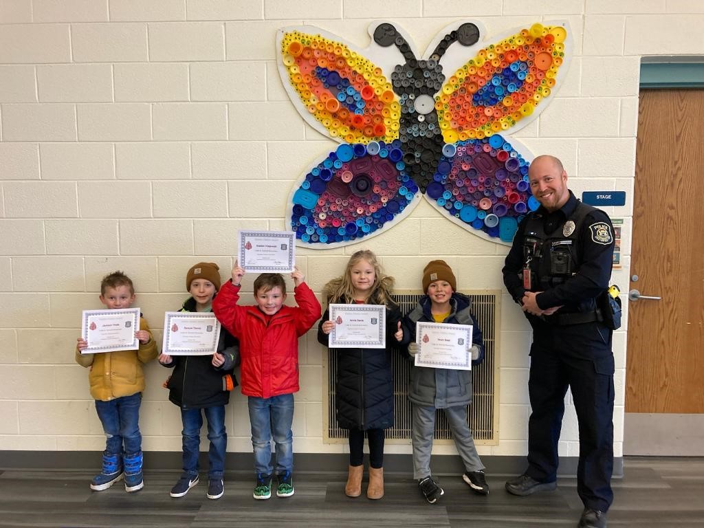 Officer Ryan Wilson with students who earned a Golden Citation