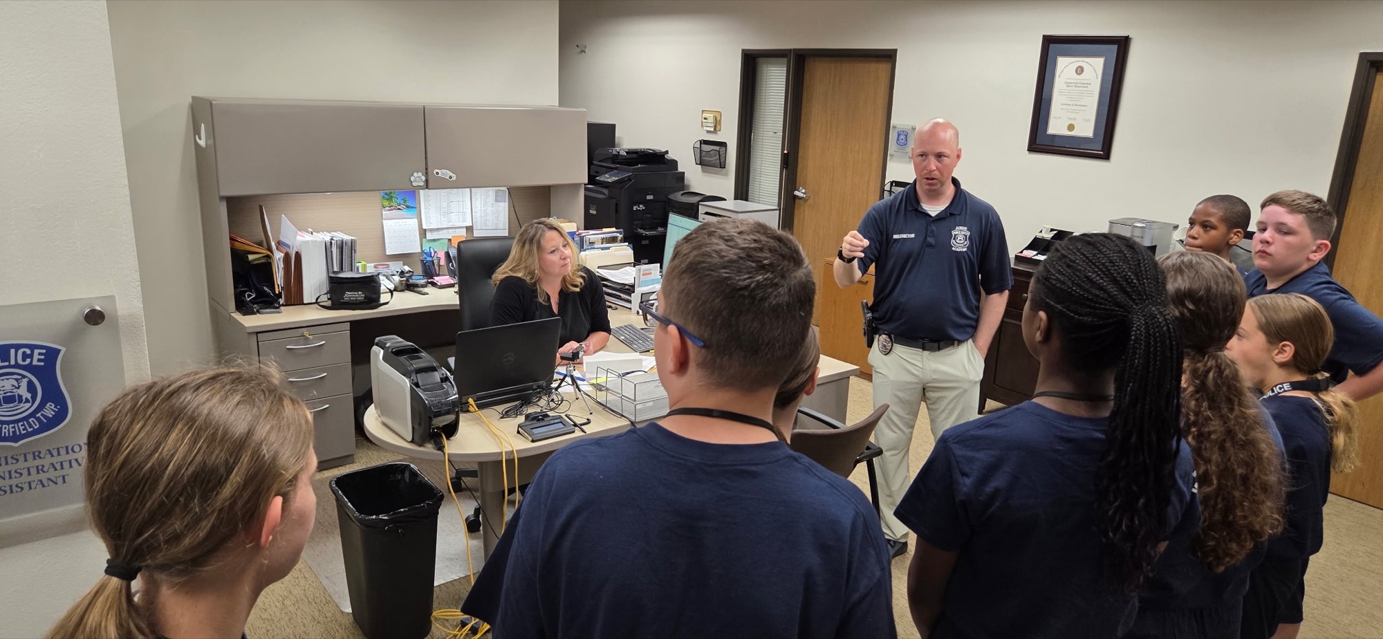 Officer Ryan Wilson showing Junior Public Safety Academy students the department offices