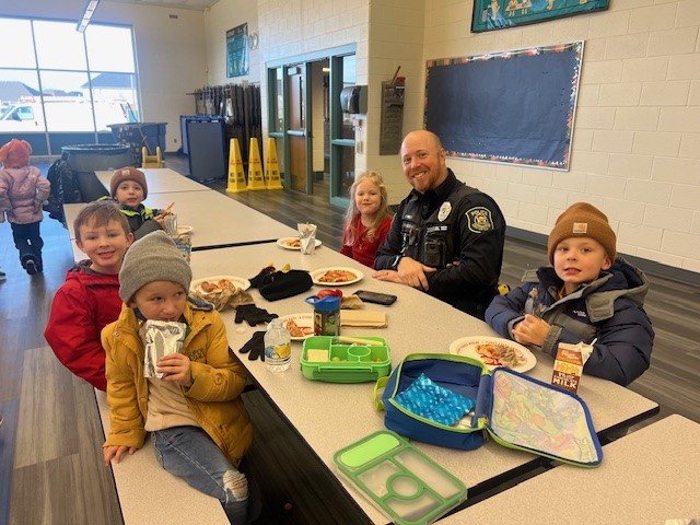 Officer Ryan Wilson at a Golden Citation pizza lunch with students